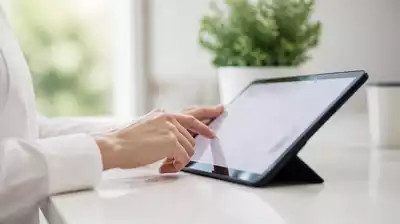 User submitting online form on tablet